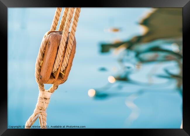 Nautical pulley with ropes of a classic sailing boat and blue sea water background Framed Print by Alex Winter