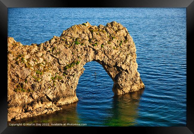 Paddle Boarding Through Durdle Door Framed Print by Martin Day