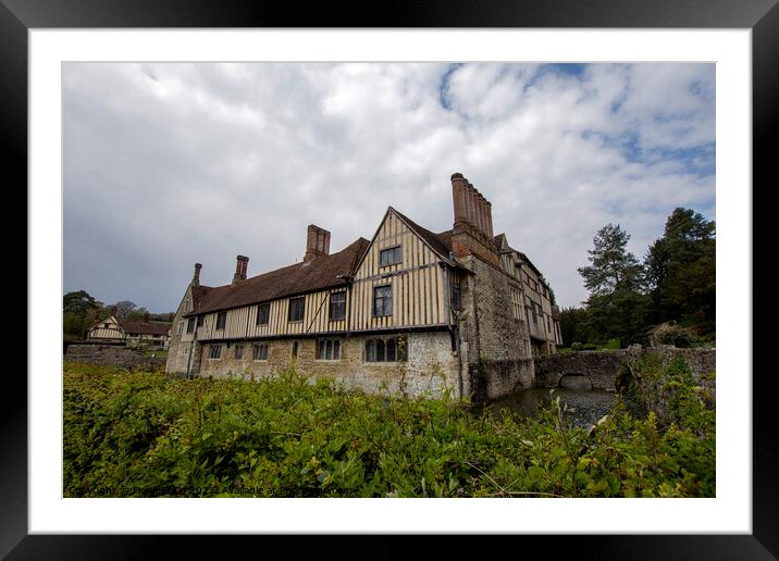 Ightham Mote under a cloudy sky  Framed Mounted Print by Fiona Etkin