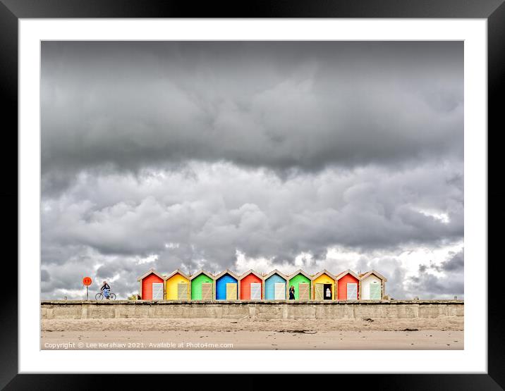 Stormy clouds over beach huts Framed Mounted Print by Lee Kershaw