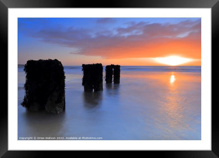 Groynes on the beach at sunrise Framed Mounted Print by Drew Watson