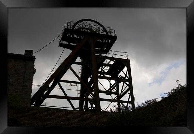 Silhouette of abandoned pit head winding gear, South Wales Framed Print by Gordon Dixon