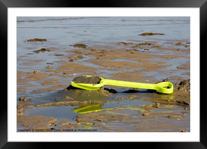 Abandoned yellow spade on Weymouth beach Framed Mounted Print by Gordon Dixon