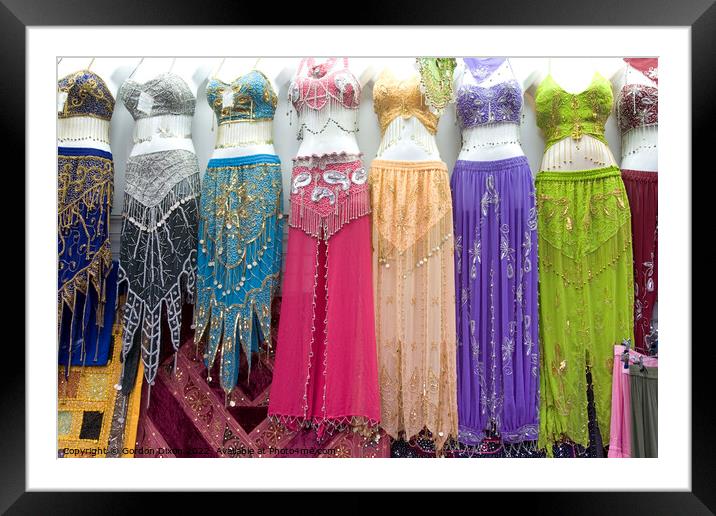 Belly dancer's dresses for sale in the cloth souk, Bur Dubai, UAE Framed Mounted Print by Gordon Dixon