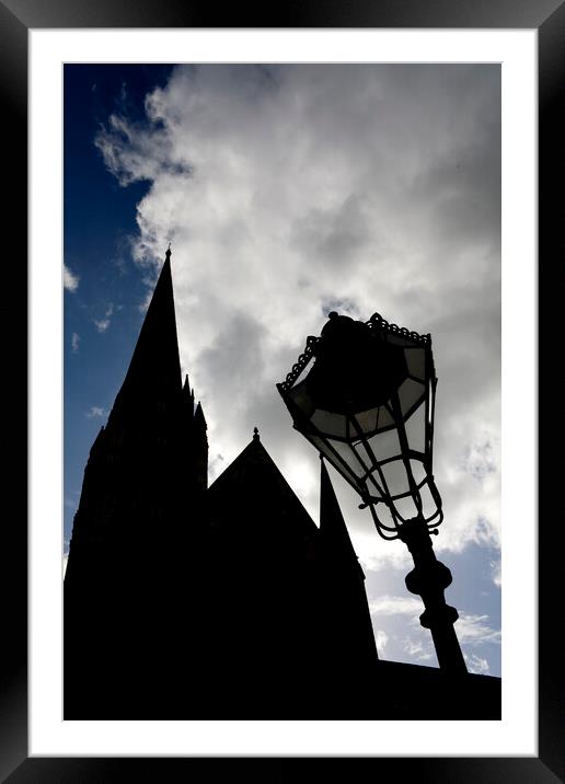 Iconic spire of Salisbury Cathedral and ornate street lamp in silhouette Framed Mounted Print by Gordon Dixon