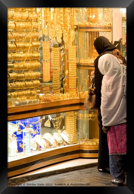 2 ladies shop for gold in the Dubai gold souk Framed Print by Gordon Dixon
