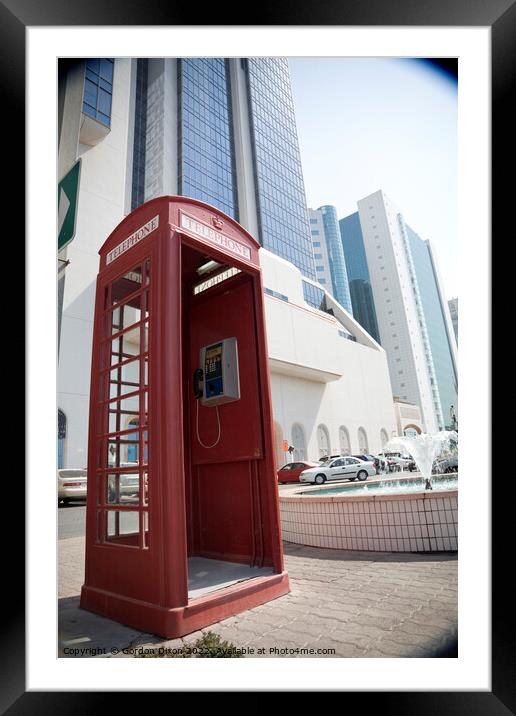 An old British telephone box stood on the pavement in Dubai  Framed Mounted Print by Gordon Dixon
