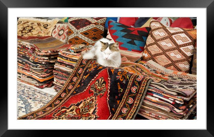 Colourful Turkish rugs and cushions with sleeping cat - Outdoor market, Istanbul Framed Mounted Print by Gordon Dixon