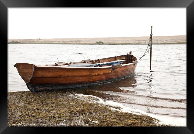 Rowing boat moored in Fleet lagoon, Chesil Bank, Dorset Framed Print by Gordon Dixon