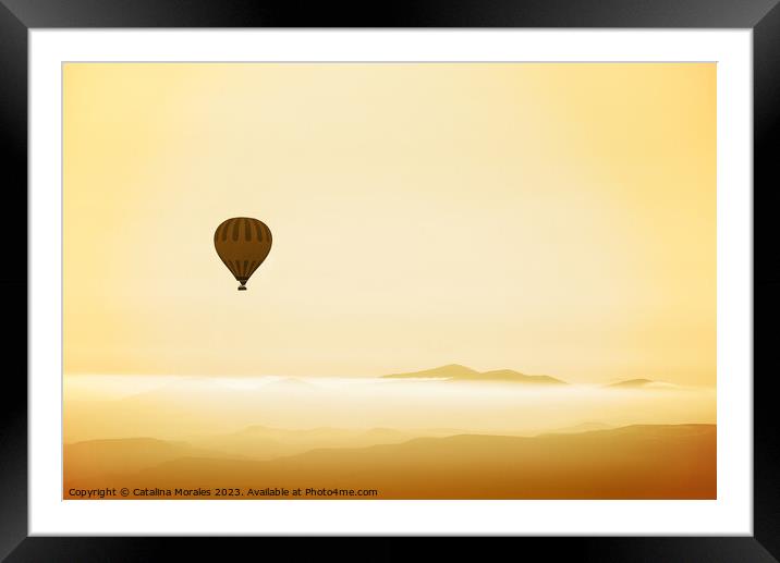 Hot air balloon over mountains in dawn mist Framed Mounted Print by Catalina Morales