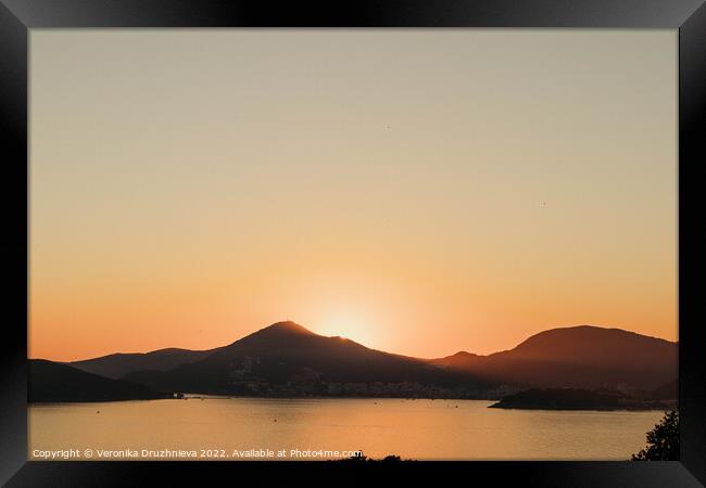 A sunset over a body of water, Montenegro  Framed Print by Veronika Druzhnieva