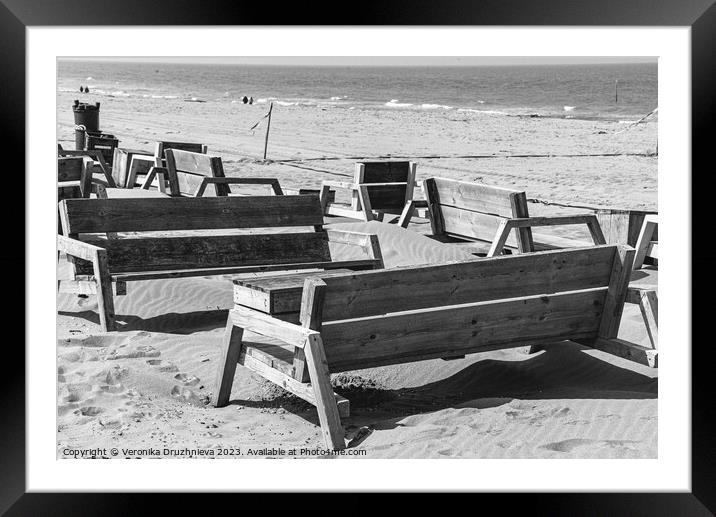 Wodden benches on the beach on Den Haag Framed Mounted Print by Veronika Druzhnieva