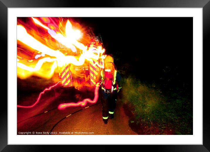 Firefighter in breathing apparatus and fire appliance with blurred lights at a fire Framed Mounted Print by Rose Sicily