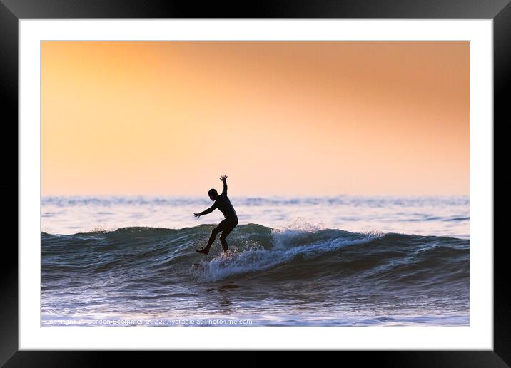 An acrobatic surfer riding a wave in Fistral Bay i Framed Mounted Print by Gordon Scammell