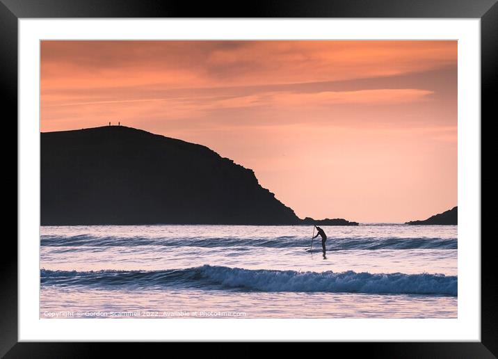Evening light over a paddle boarder in Fistral Bay Framed Mounted Print by Gordon Scammell