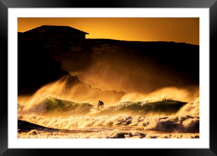 Surfing in wild seas during a golden sunset at Fis Framed Mounted Print by Gordon Scammell