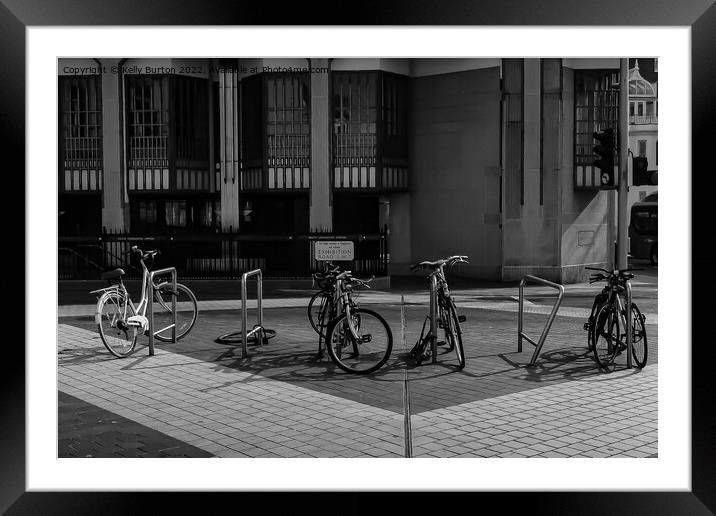 Row of bikes in the street. Framed Mounted Print by Kelly Burton