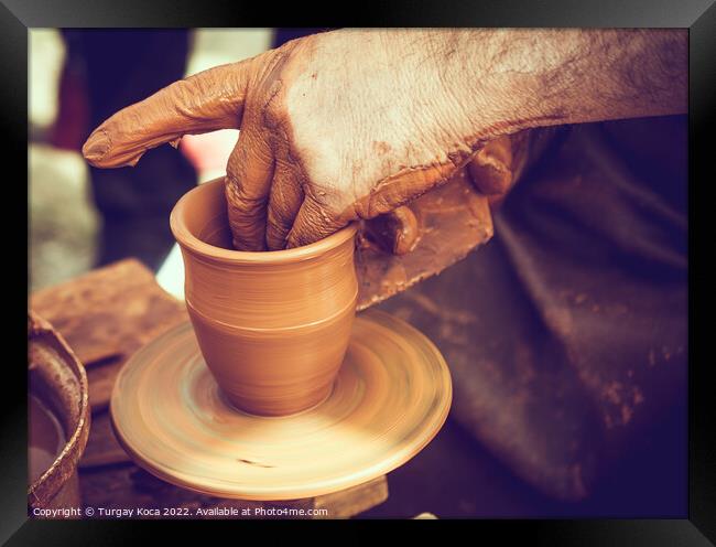 Potter`s hands shaping up the clay Framed Print by Turgay Koca