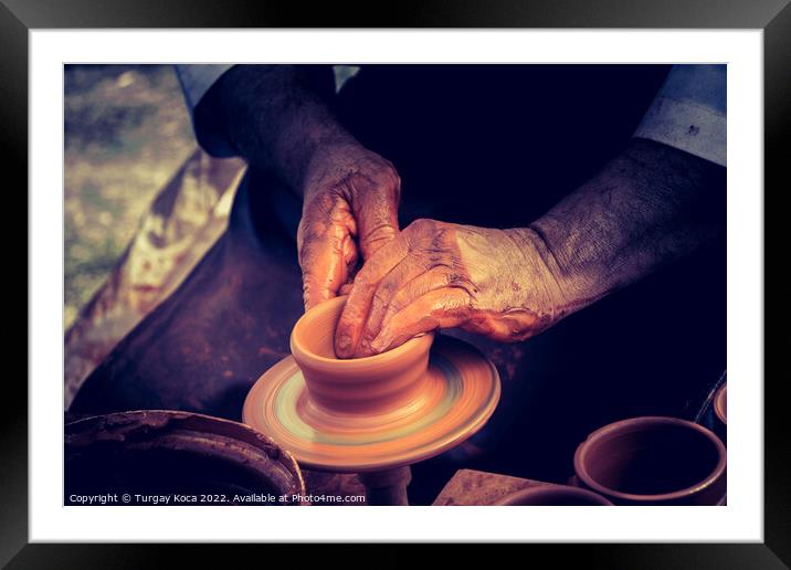 Potter`s hands shaping up the clay Framed Mounted Print by Turgay Koca