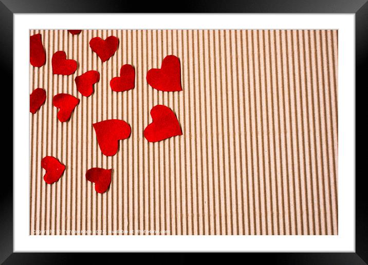 Red color paper hearts on a brown cardboard Framed Mounted Print by Turgay Koca