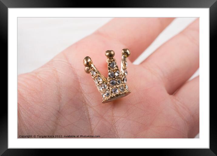 Little model crown is placed in hand Framed Mounted Print by Turgay Koca