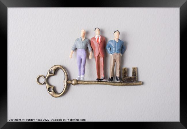 Tiny figurine of man model and retro key Framed Print by Turgay Koca