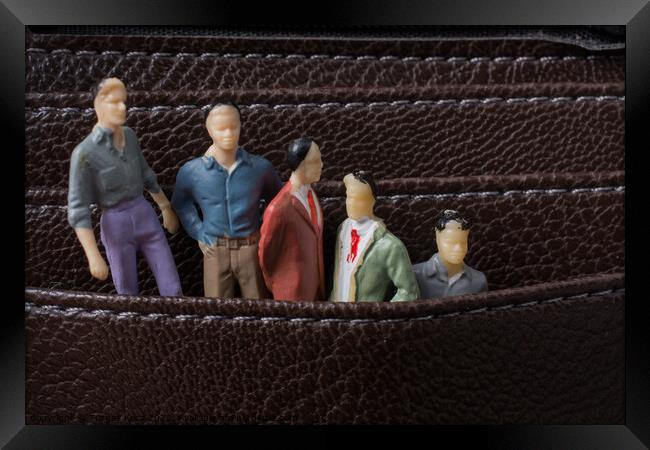Tiny figurine of men model  in pockets Framed Print by Turgay Koca