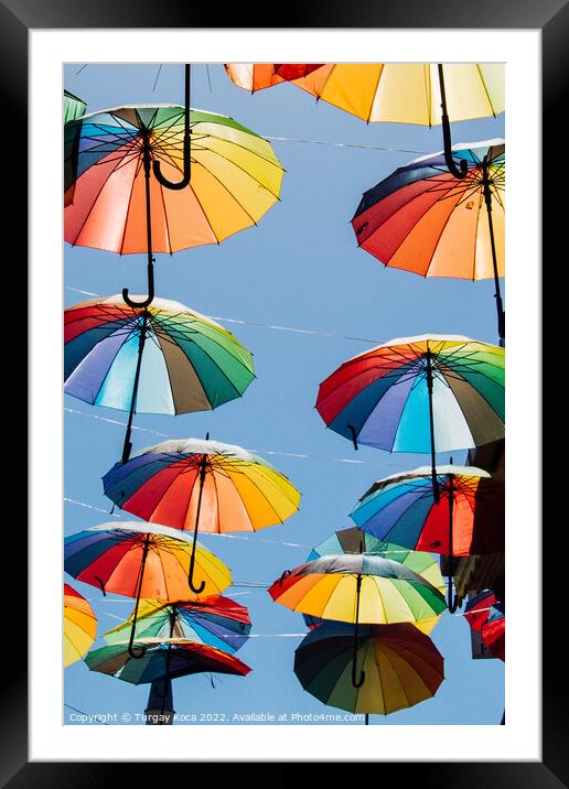 Colored umbrellas hanging above the street Framed Mounted Print by Turgay Koca