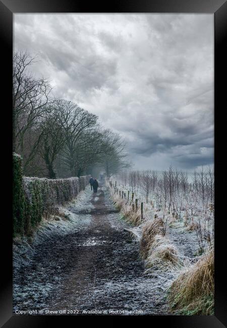 Ramblers Walking Along a Long Muddy Path on a Misty Winter Morning. Framed Print by Steve Gill