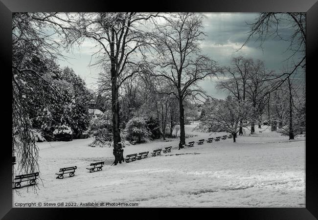 Row of Seats Along a Snow Covered Park on a wintry January morning.  Framed Print by Steve Gill