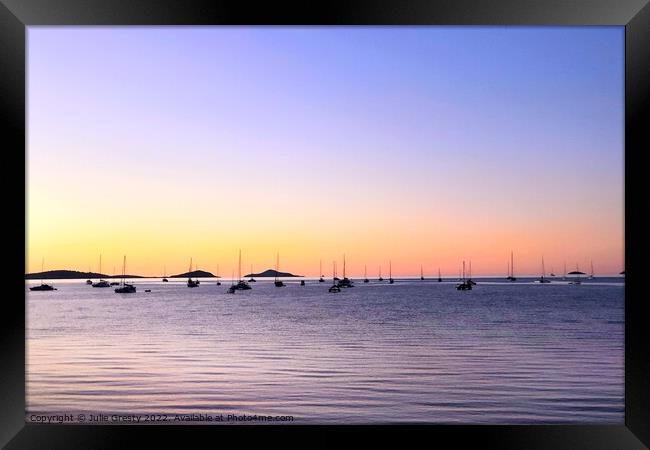 Boats in Silhouette against a Rainbow Sunset Framed Print by Julie Gresty