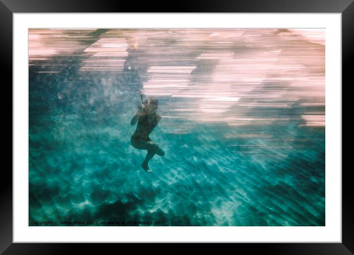Woman diving underwater for snorkeling Framed Mounted Print by Simo Wave
