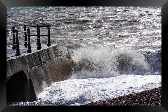 Waves breaking against concrete Framed Print by Sally Wallis