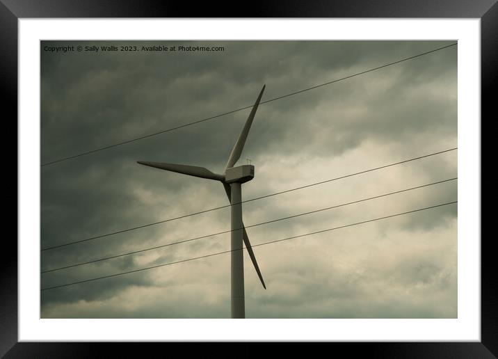 Wind turbine against clouds Framed Mounted Print by Sally Wallis