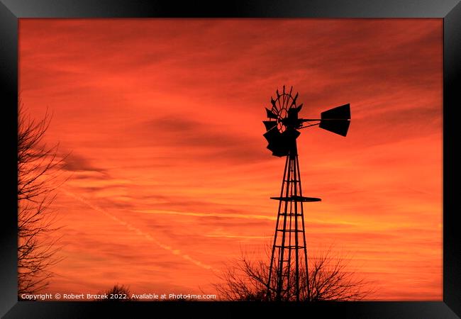 Kansas Sunset with red sky and a Windmill silhouet Framed Print by Robert Brozek