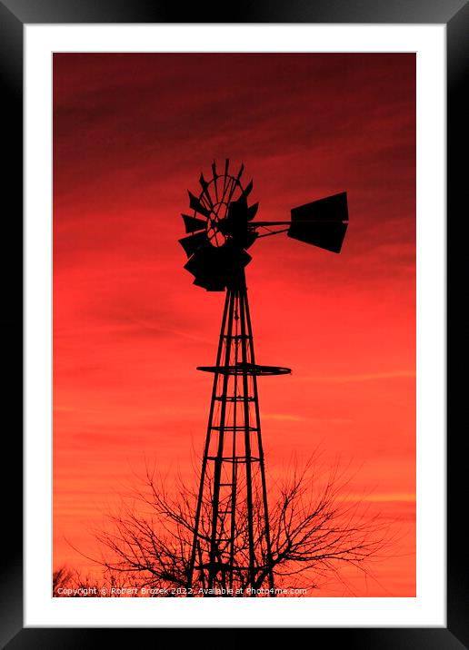 Kansas Sunset with a red Sky and Windmill silhouet Framed Mounted Print by Robert Brozek