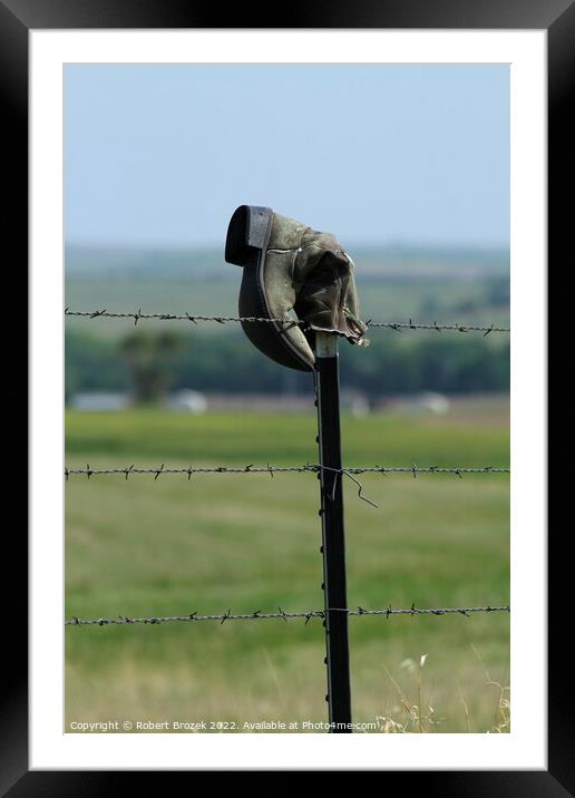 Cowboy boot on a fence with grass Framed Mounted Print by Robert Brozek