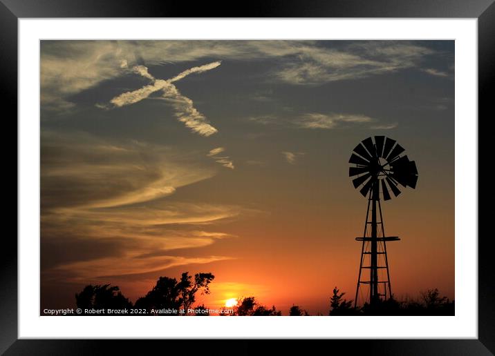 sunset with windmill and sky with cross Framed Mounted Print by Robert Brozek