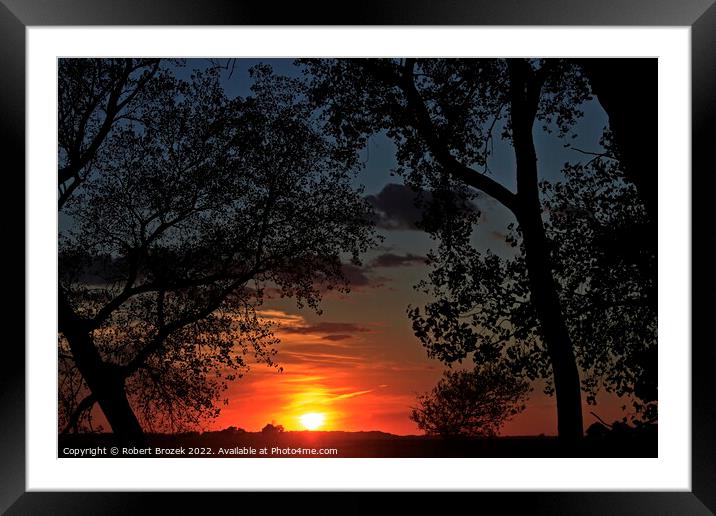 Sky and sun with trees at sunset Framed Mounted Print by Robert Brozek