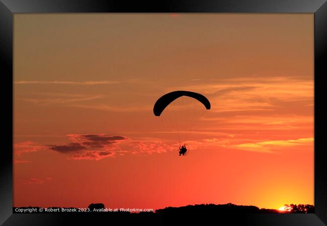 Paraglider at Sunset with a colorful sky. Framed Print by Robert Brozek
