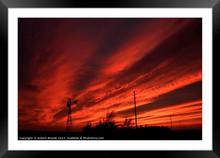 Kansas Blazing Red Sunset with a Windmill Silhouette Framed Mounted Print by Robert Brozek
