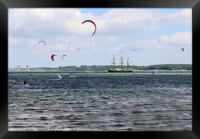 Lots of kite surfing activity at the Baltic Sea beach of Laboe i Framed Print by Michael Piepgras