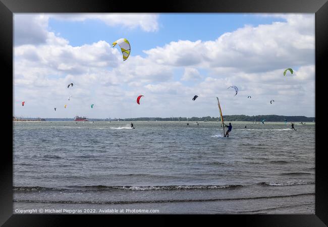 Lots of kite surfing activity at the Baltic Sea beach of Laboe i Framed Print by Michael Piepgras