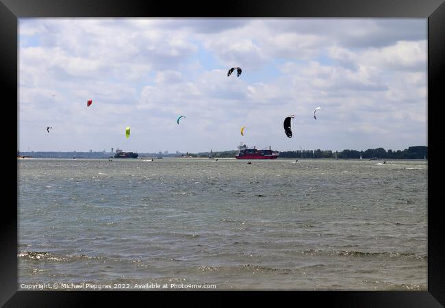 Lots of kite surfing activity at the Baltic Sea beach of Laboe i Framed Print by Michael Piepgras