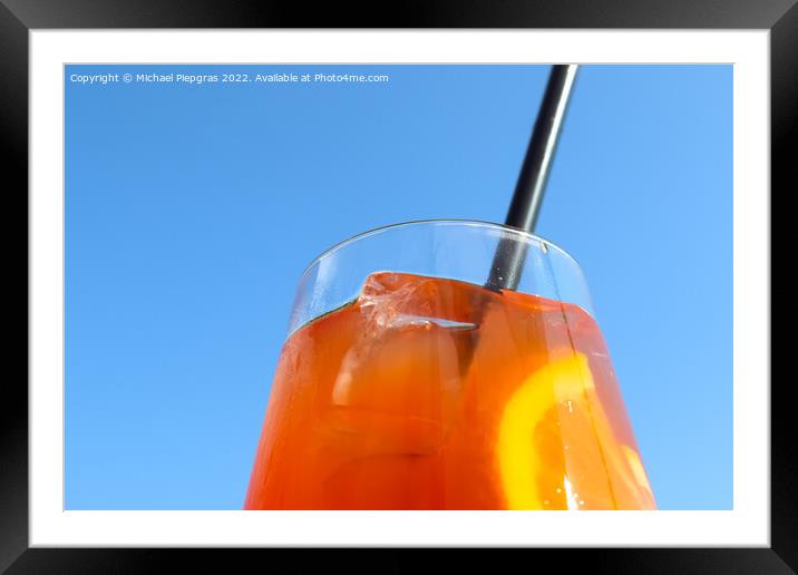 Refreshing orange summer cocktails with ice against a blue sky b Framed Mounted Print by Michael Piepgras