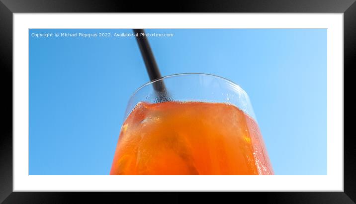 Refreshing orange summer cocktails with ice against a blue sky b Framed Mounted Print by Michael Piepgras