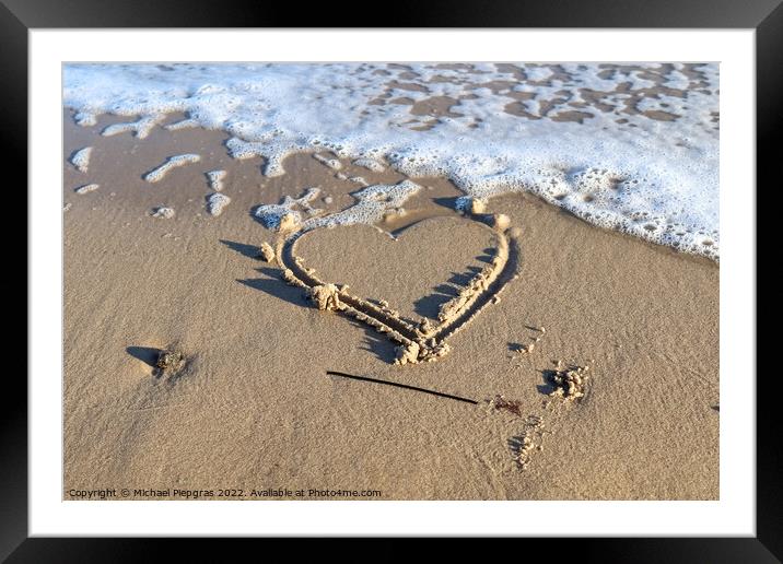 A beautiful heart shape painted into the sand of a baltic sea be Framed Mounted Print by Michael Piepgras