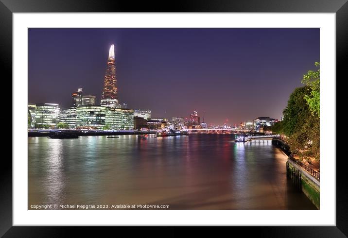 View of the London skyline at night with river thamse and lots of light Framed Mounted Print by Michael Piepgras