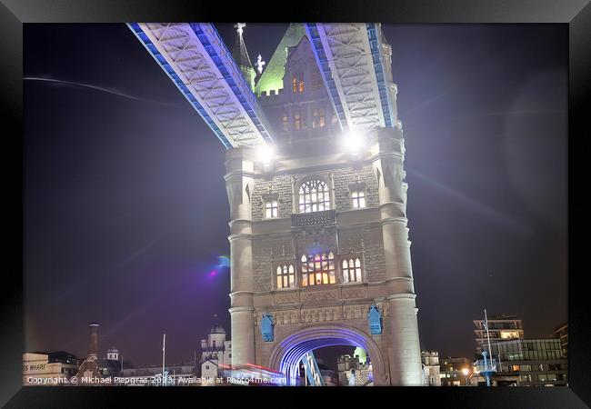 The Tower Bridge in London at night with colorful lights Framed Print by Michael Piepgras