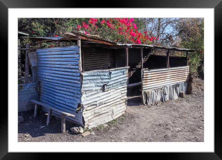 Old abandoned huts on the side of African roads in poor regions. Framed Mounted Print by Michael Piepgras